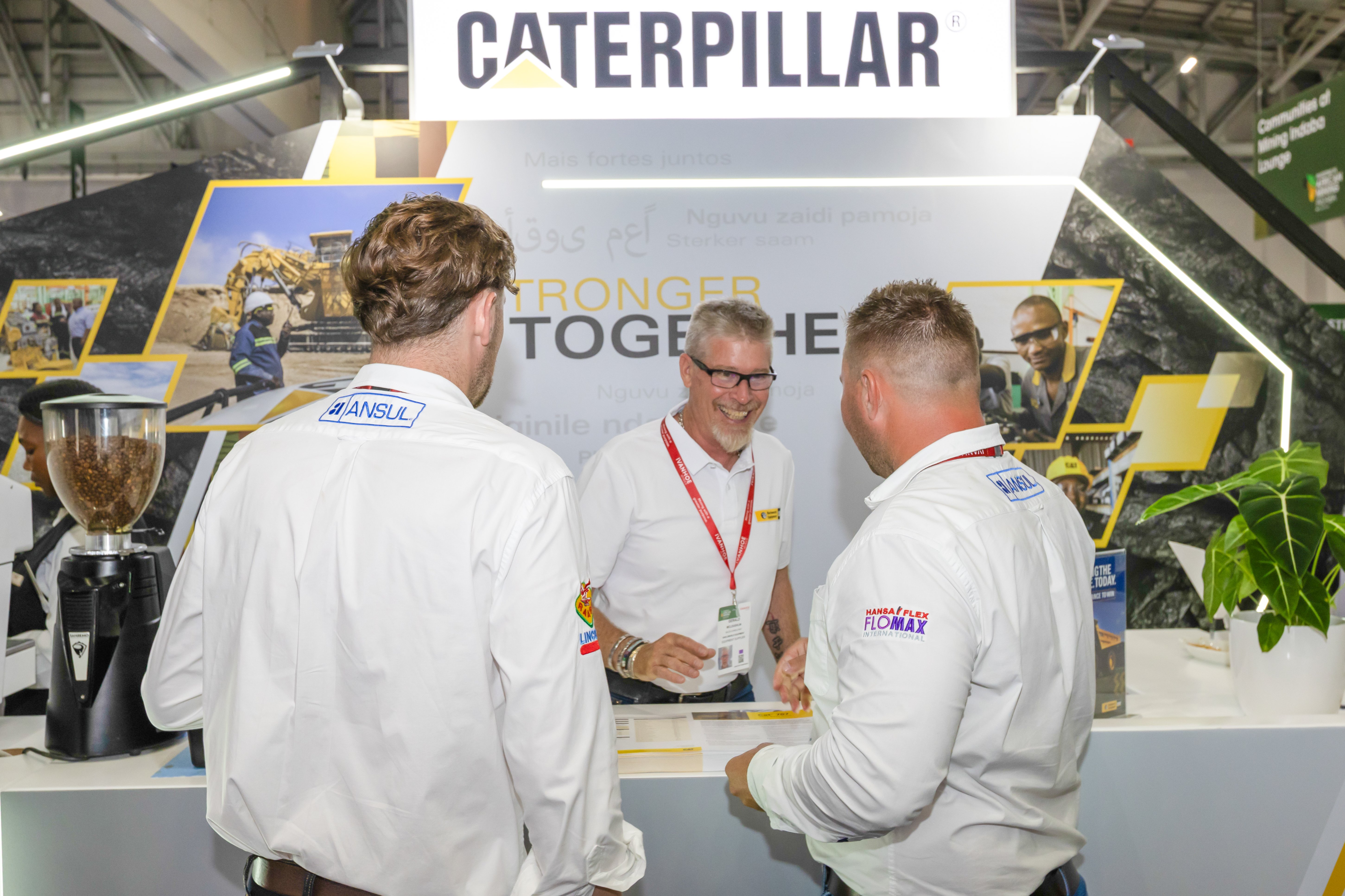 Customers by the CAT stall at the Mining Indaba event